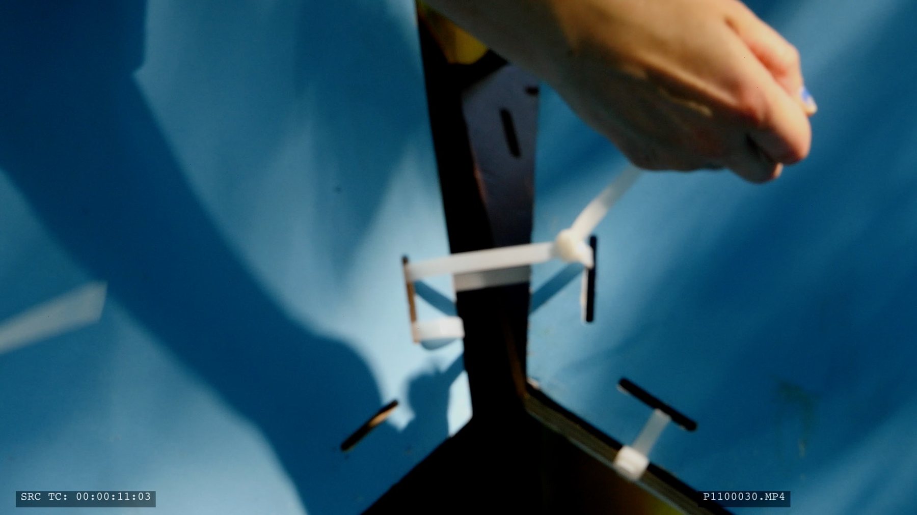 Detail of hands assembling a hexagonal panel joint, Borgåsen