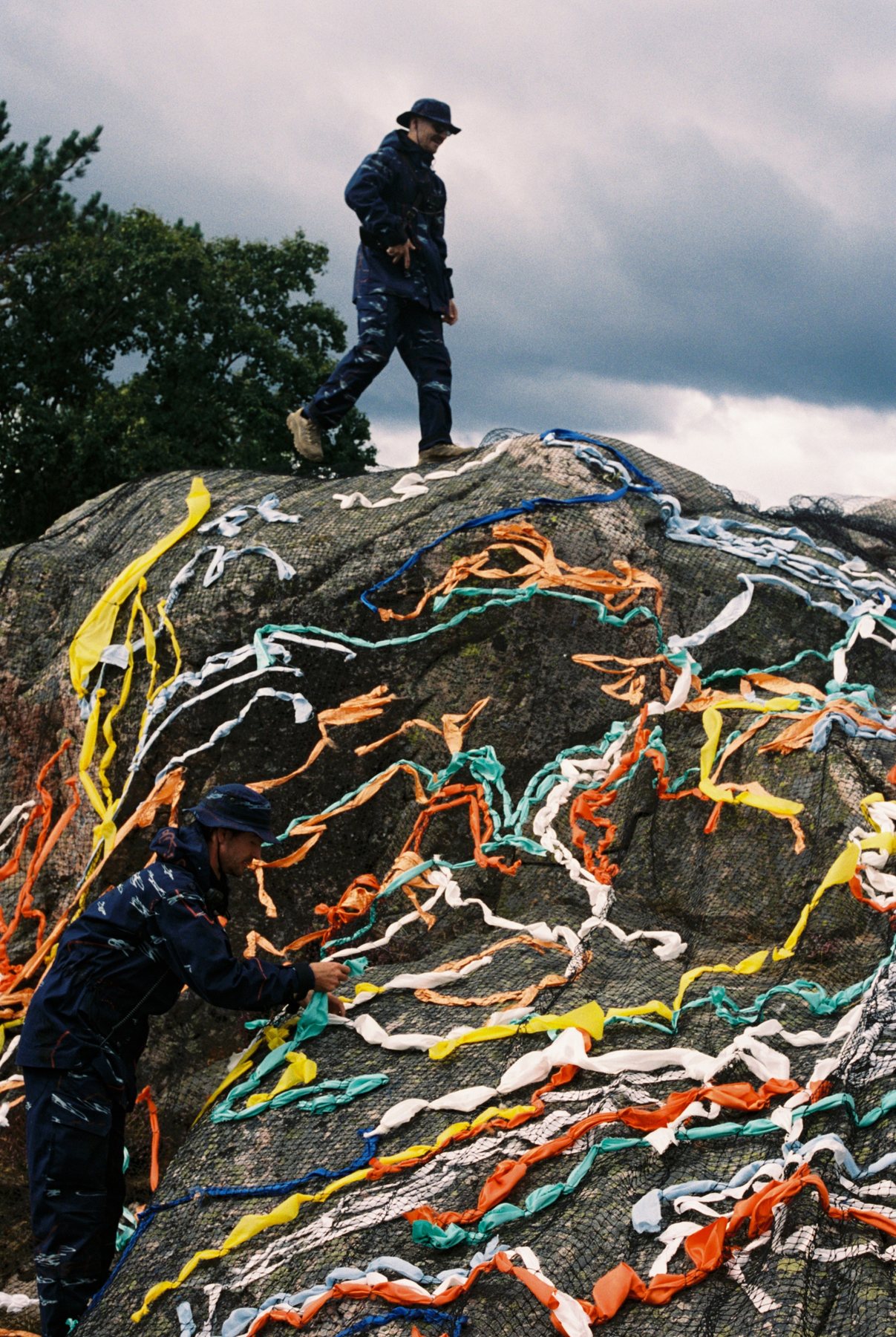 Figure on rock with trailing coloured lines, Dybingen II
