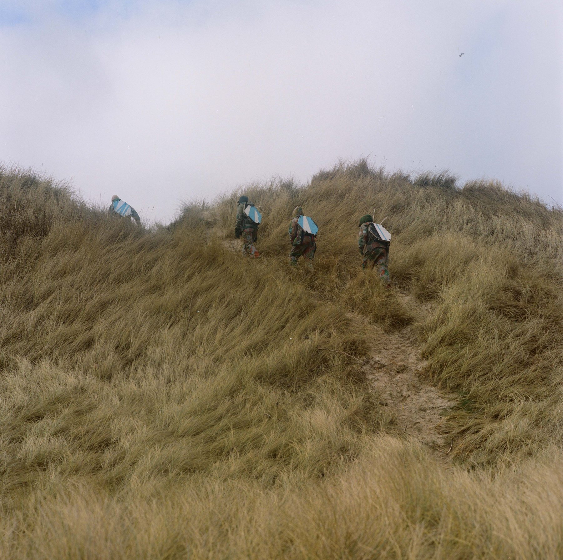 Figures walking a path through dune grass toward the coast, Furreby
