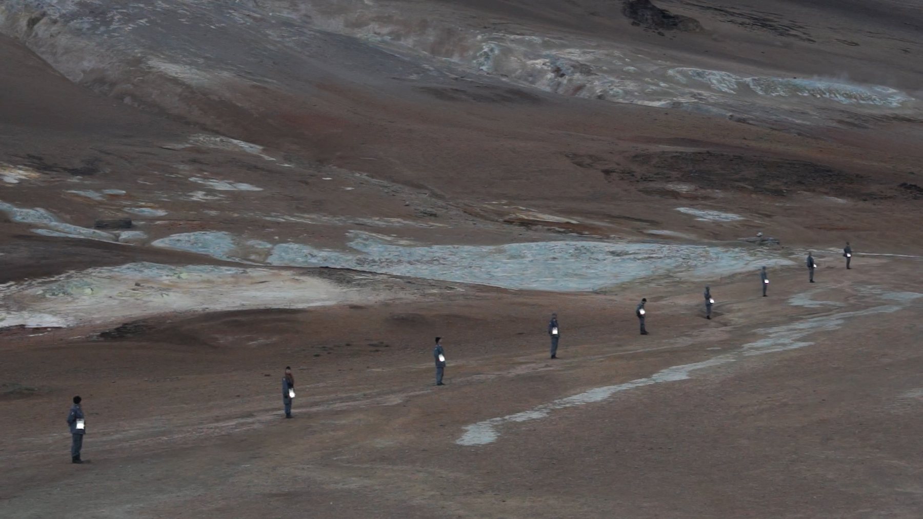 Line of figures crossing the geothermal field at Hverir, near Námafjall